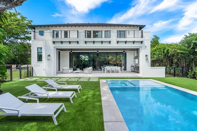 7001 SW 71st Ave, Miami, FL 33143 - back of house with a balcony, a ceiling fan, stucco siding, a patio area, and a pool with connected hot tub