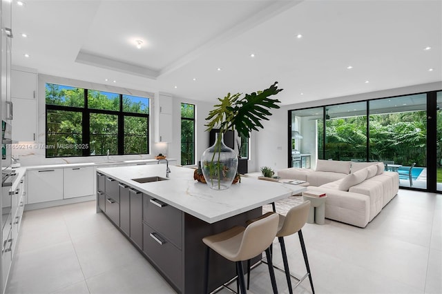 7001 SW 71st Ave, Miami, FL 33143 - kitchen featuring modern cabinets, white cabinetry, a large island, healthy amount of natural light, and recessed lighting