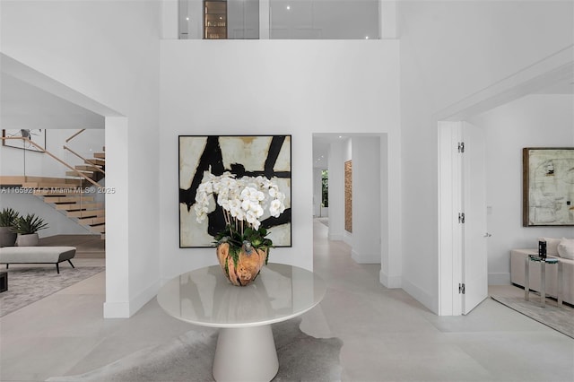 7001 SW 71st Ave, Miami, FL 33143 - foyer with stairway, baseboards, and a towering ceiling