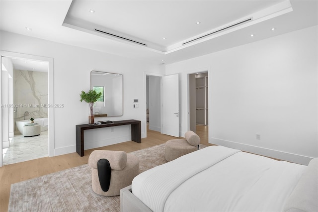 7001 SW 71st Ave, Miami, FL 33143 - bedroom with a raised ceiling, light wood finished floors, recessed lighting, baseboards, and ensuite bath
