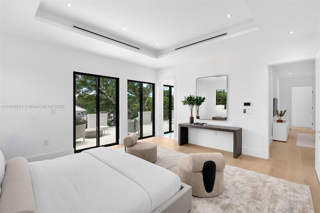 7001 SW 71st Ave, Miami, FL 33143 - bedroom featuring a tray ceiling, access to exterior, light wood-style floors, recessed lighting, and baseboards