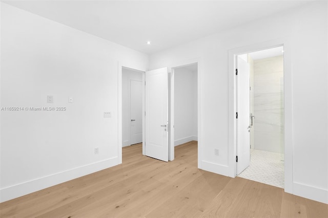 7001 SW 71st Ave, Miami, FL 33143 - unfurnished bedroom featuring light wood finished floors, a walk in closet, baseboards, recessed lighting, and connected bathroom