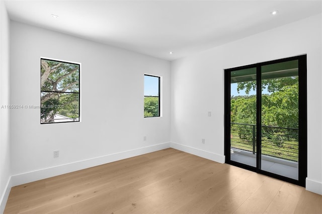 7001 SW 71st Ave, Miami, FL 33143 - empty room featuring plenty of natural light, light wood-style flooring, baseboards, and recessed lighting