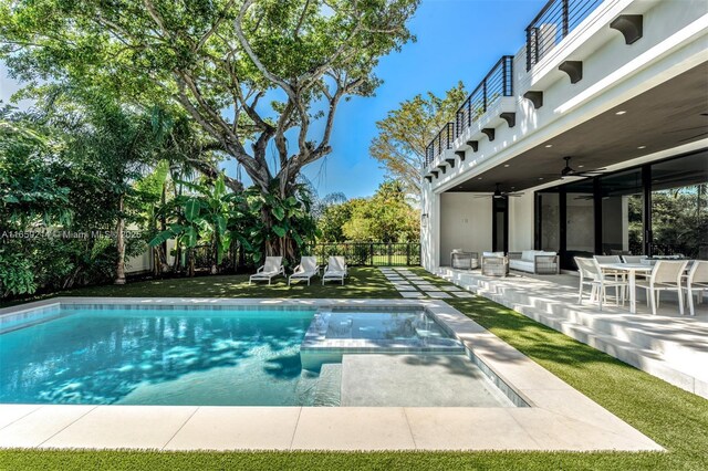 7001 SW 71st Ave, Miami, FL 33143 - view of swimming pool featuring a fenced backyard, a ceiling fan, a patio area, outdoor lounge area, and a pool with connected hot tub