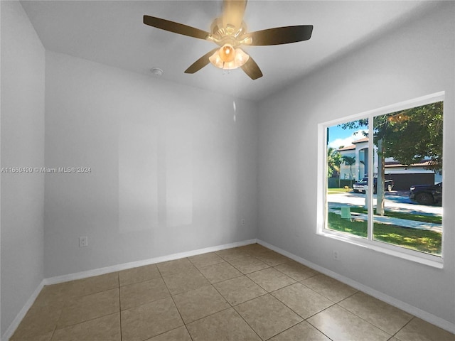 spare room featuring light tile patterned floors and ceiling fan