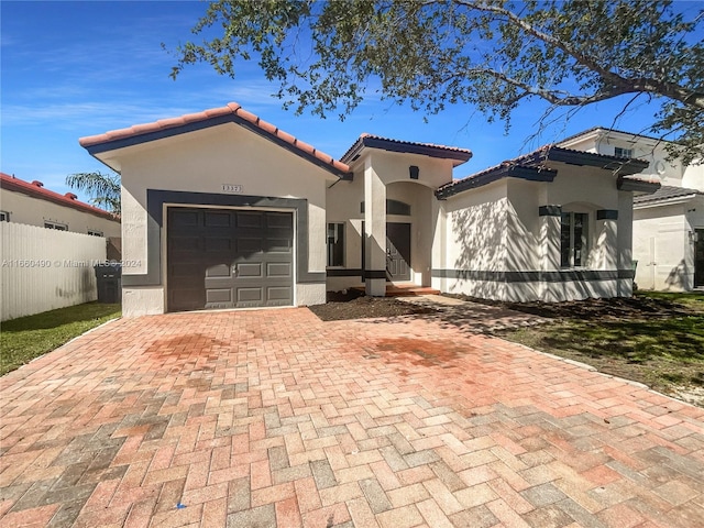 mediterranean / spanish-style home with a garage