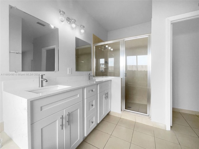 bathroom featuring vanity, an enclosed shower, and tile patterned floors