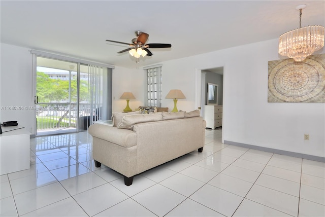 tiled living room featuring ceiling fan with notable chandelier