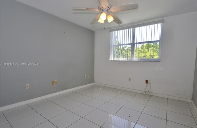 tiled spare room with ceiling fan