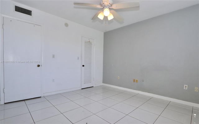 unfurnished room with light tile patterned flooring and ceiling fan