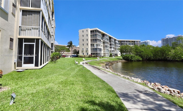 surrounding community with a yard and a water view