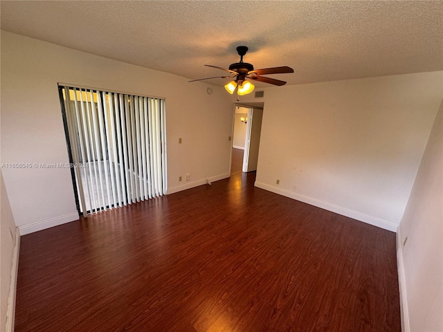 spare room featuring ceiling fan, dark hardwood / wood-style floors, and a textured ceiling