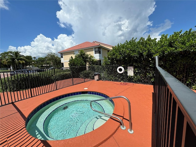 view of swimming pool featuring a community hot tub