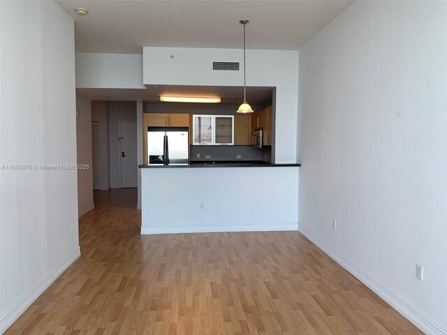 spare room with a water view and dark wood-type flooring