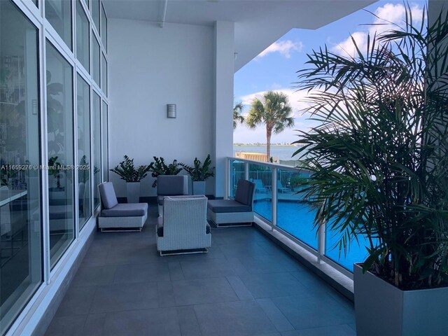 view of swimming pool featuring a water view and a patio area