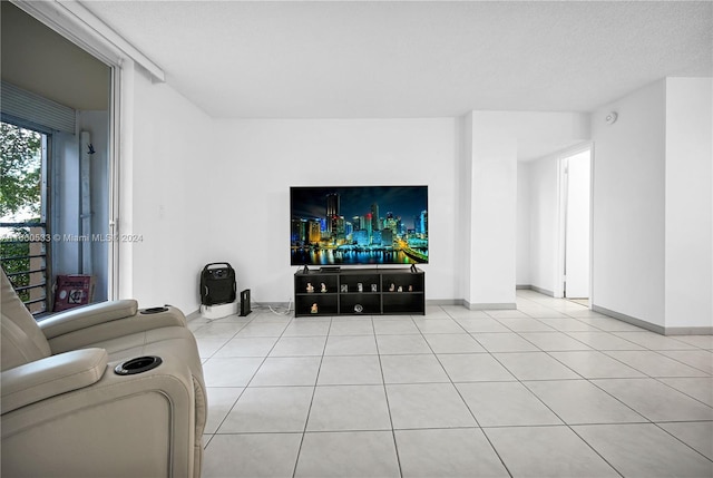 tiled living room featuring a textured ceiling