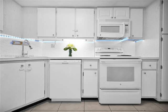 kitchen featuring white cabinetry, sink, backsplash, white appliances, and light tile patterned flooring