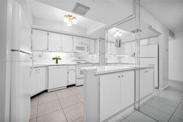 kitchen featuring white appliances, white cabinets, light tile patterned floors, a textured ceiling, and tasteful backsplash