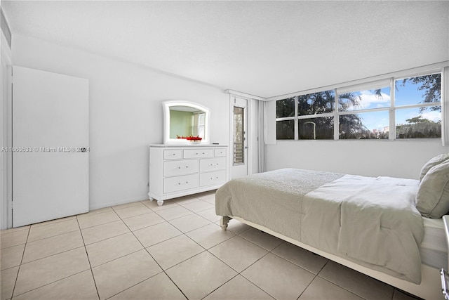 bedroom featuring light tile patterned flooring