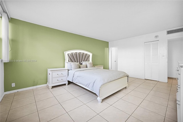 tiled bedroom with a closet