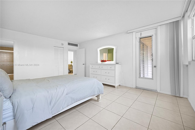 bedroom with light tile patterned floors