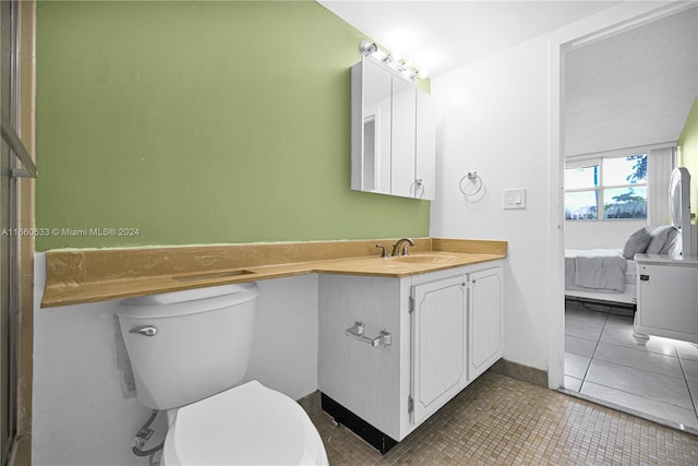 bathroom with tile patterned floors, vanity, and toilet