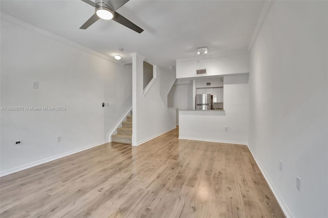 unfurnished living room featuring light hardwood / wood-style flooring, ceiling fan, and ornamental molding