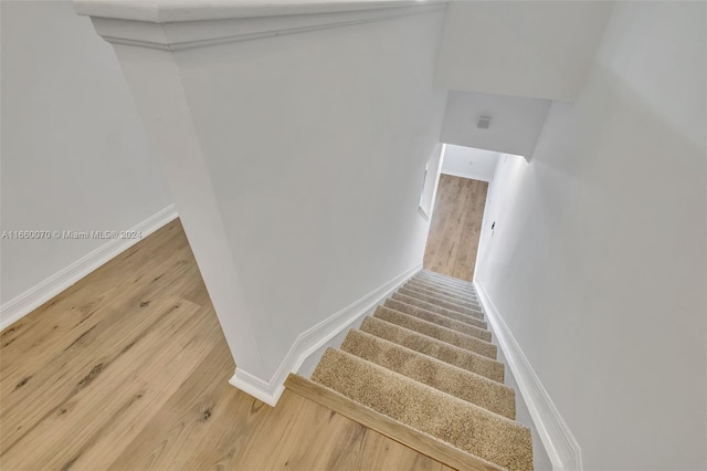 stairway featuring wood-type flooring