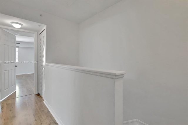 corridor with light hardwood / wood-style floors