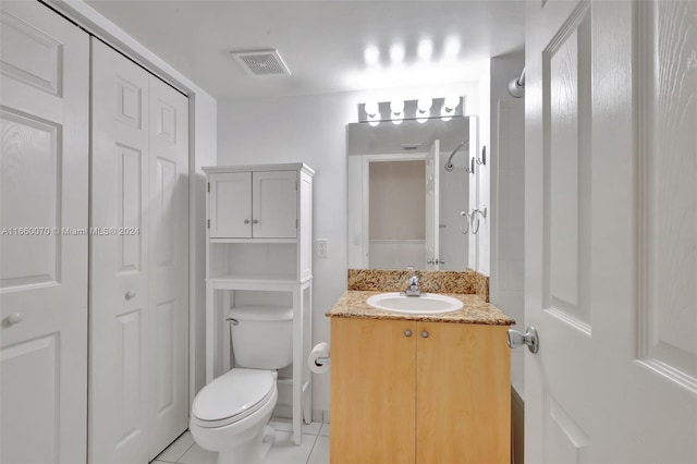 bathroom with vanity, toilet, and tile patterned floors