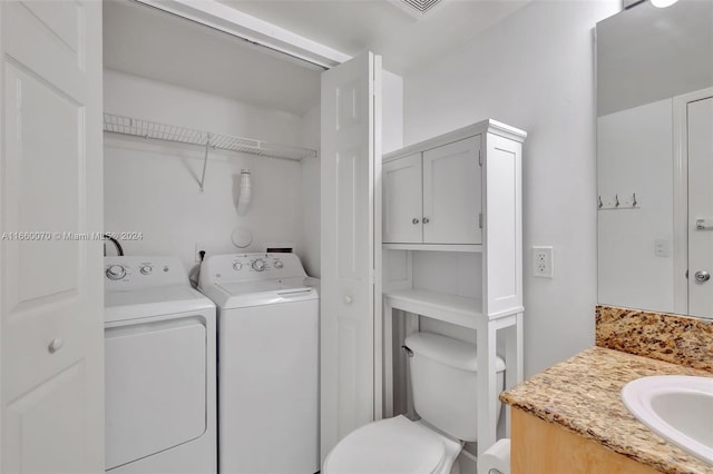 washroom featuring separate washer and dryer and sink