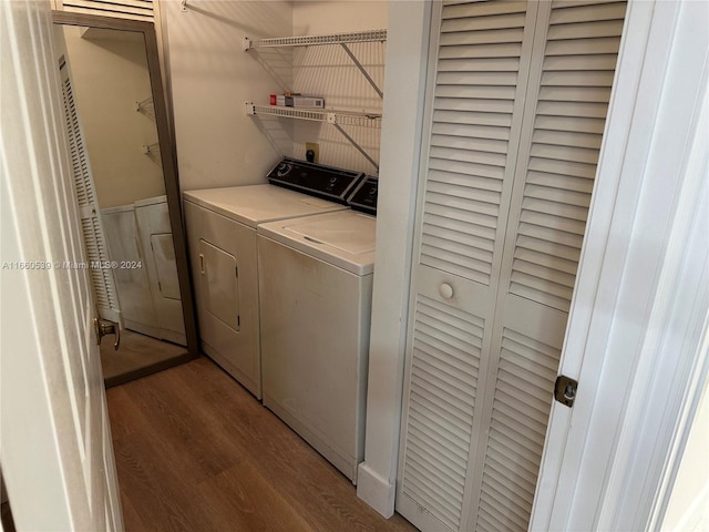 washroom featuring hardwood / wood-style floors and separate washer and dryer