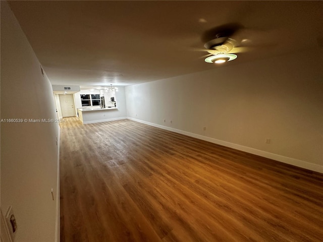 unfurnished living room with ceiling fan and hardwood / wood-style flooring