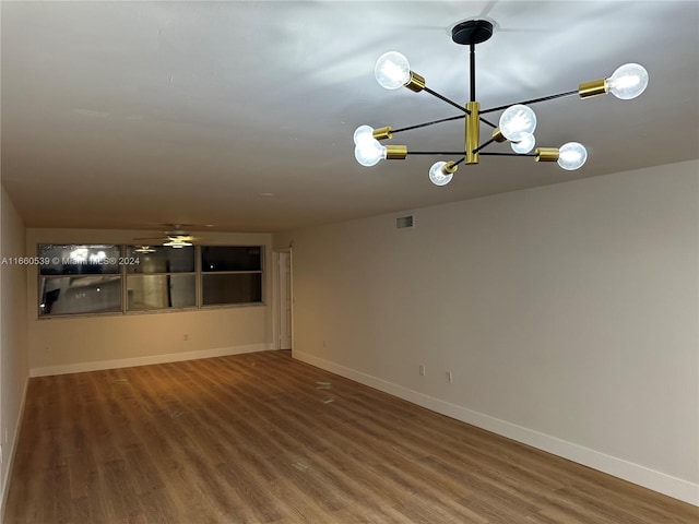 unfurnished room featuring ceiling fan and hardwood / wood-style flooring