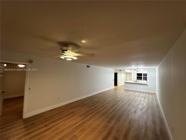 unfurnished living room featuring ceiling fan and hardwood / wood-style flooring