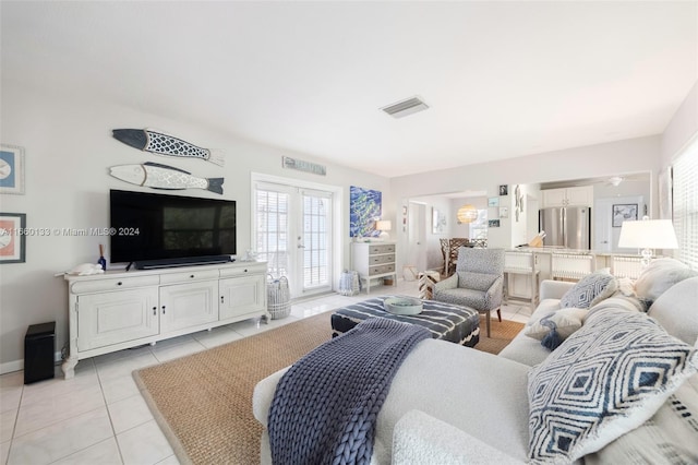 living room with light tile patterned floors and french doors