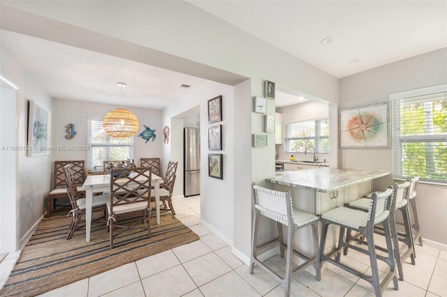 tiled dining area featuring sink