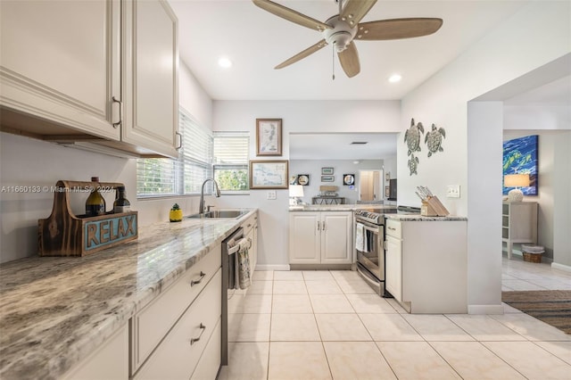 kitchen with ceiling fan, light stone counters, light tile patterned flooring, sink, and stainless steel appliances