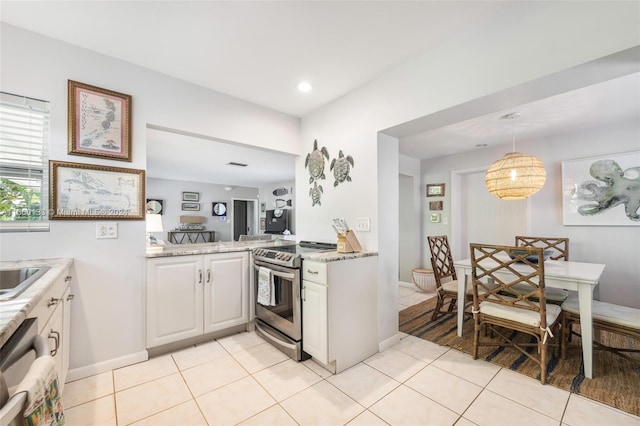 kitchen with appliances with stainless steel finishes, hanging light fixtures, light tile patterned flooring, and white cabinets