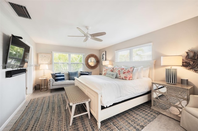 bedroom with multiple windows, ceiling fan, and tile patterned floors