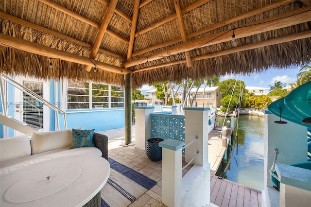 view of patio / terrace with a boat dock and a water view