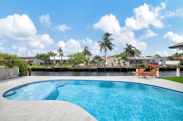 view of swimming pool featuring a water view