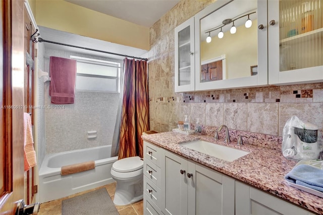 full bathroom featuring toilet, tile patterned flooring, vanity, shower / bathtub combination with curtain, and decorative backsplash