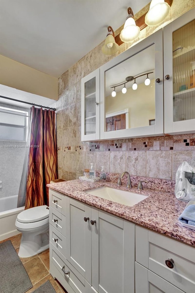 full bathroom with vanity, toilet, tasteful backsplash, and shower / bath combo