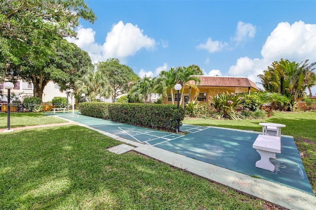 view of sport court with a yard