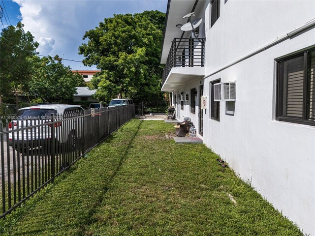 view of yard featuring a wall mounted air conditioner