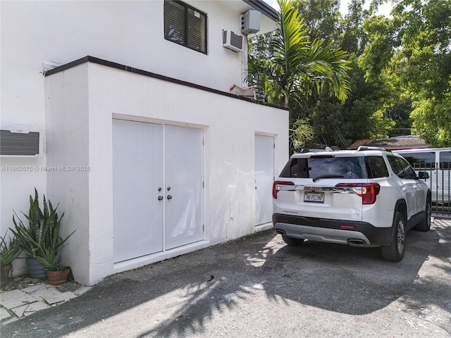 garage featuring a wall mounted air conditioner