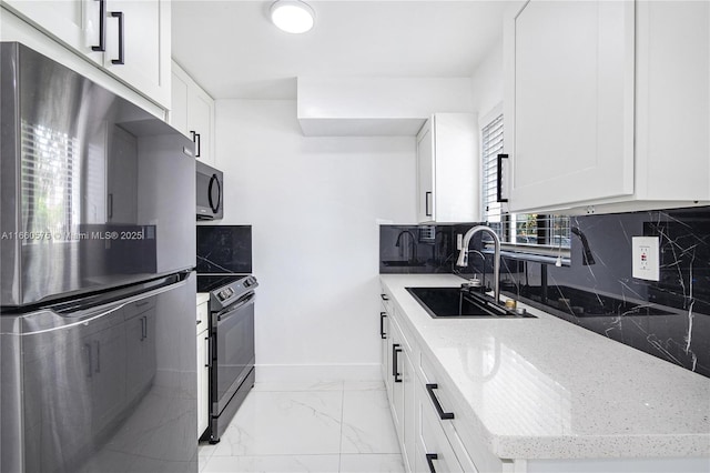 kitchen with stainless steel refrigerator, sink, electric range oven, and white cabinets