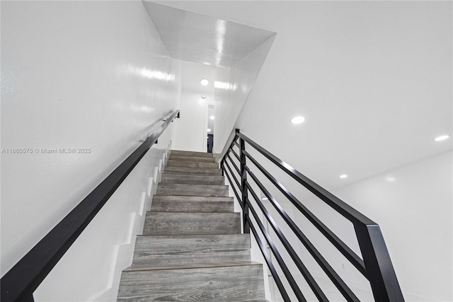 stairs featuring wood-type flooring