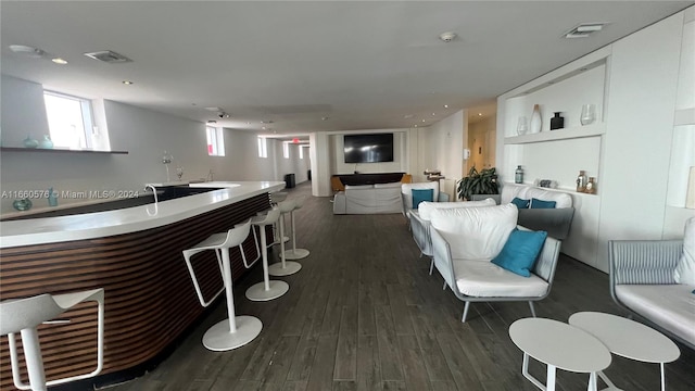 bar with dark wood-type flooring